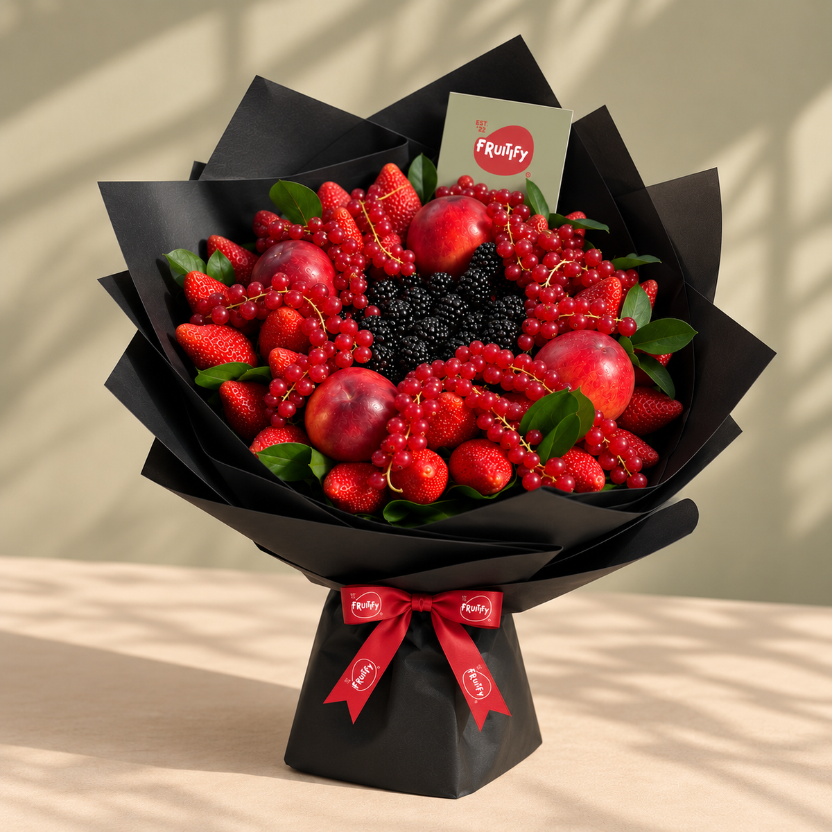 Fresh berry fruit bouquet wrapped in black paper by Fruitify