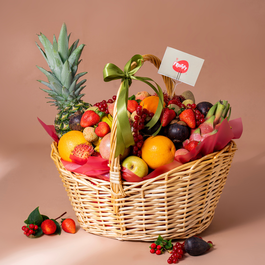 Luxury exotic fruit basket featuring pineapple, dragon fruit, strawberries, figs, lychee, oranges, grapes, and premium seasonal fruits in an elegant wicker basket, perfect for healthy gifting in Dubai and UAE.