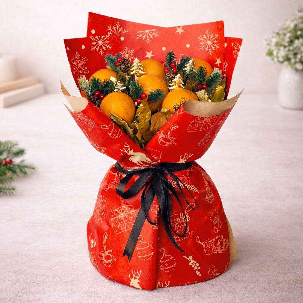 Bouquet of oranges wrapped in red festive paper with a black ribbon on a light background