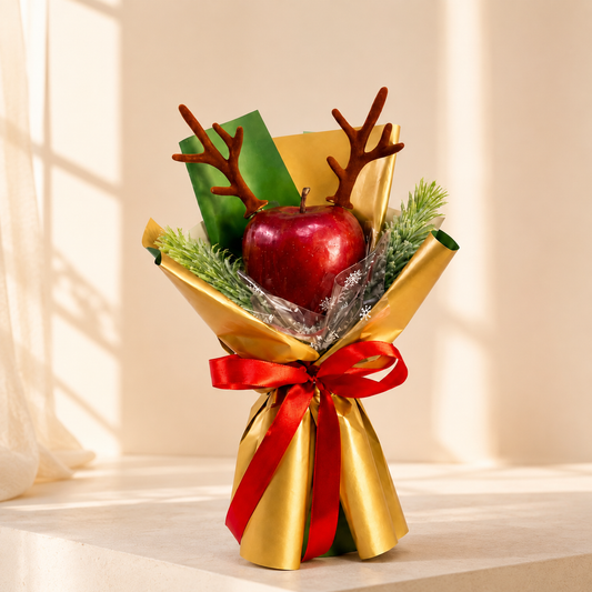Mini Christmas Apple Bouquet with fresh red apple, festive greenery, gold wrapping and red ribbon for Christmas gifting in Dubai.