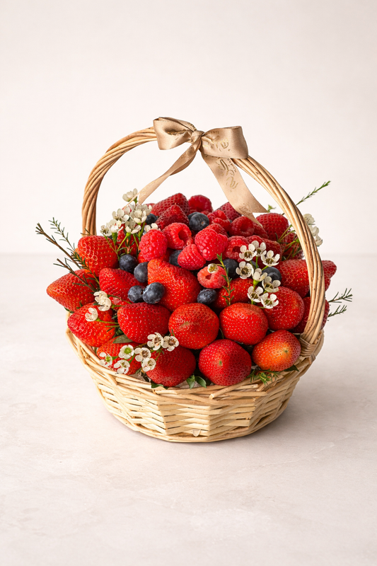 Luxury berry basket featuring fresh strawberries, raspberries, blueberries, and seasonal berries with delicate floral accents in an elegant wicker basket, perfect for gifting in Dubai