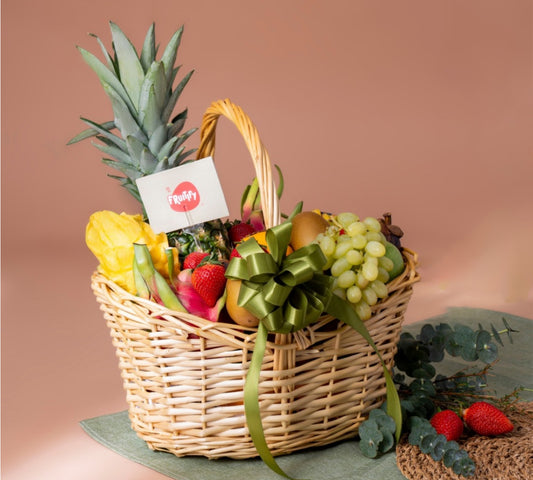 Premium exotic fruit basket with pineapple, dragon fruit, grapes, strawberries, kiwi, pears, and seasonal fruits in an elegant wicker basket, perfect for luxury healthy gifting in Dubai and UAE.