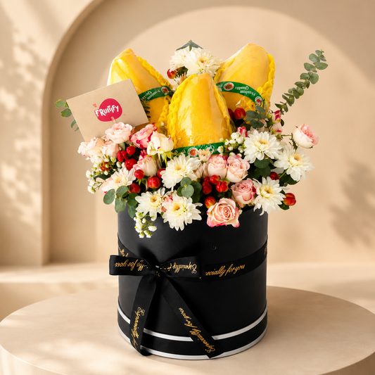 Premium mango and floral gift box with fresh mangoes, roses, chrysanthemums, eucalyptus, and luxury black box arrangement in Dubai.