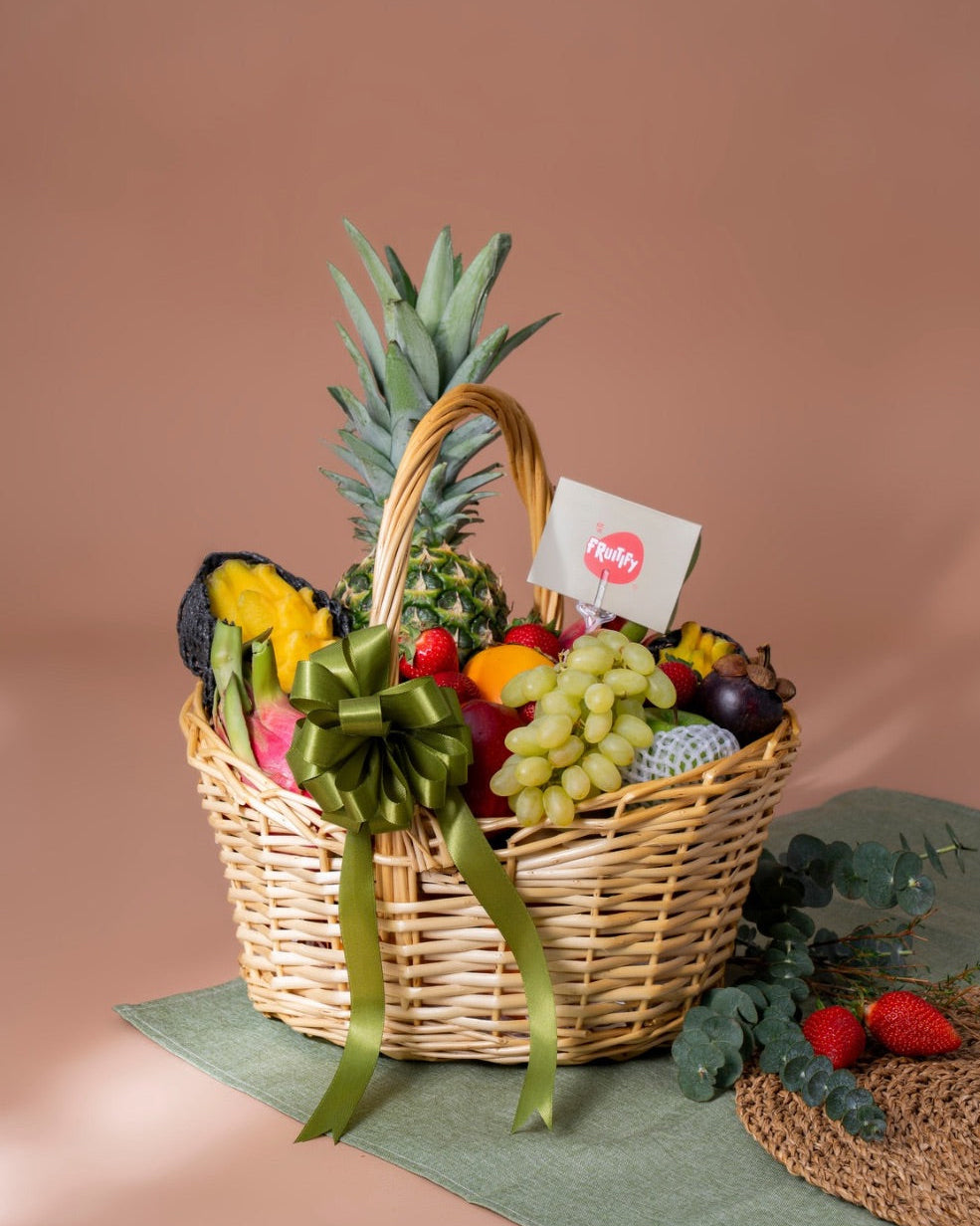 Fruit basket with a pineapple, grapes, and other fruits on a brown background
