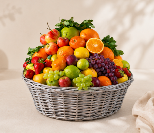 Affordable mixed fruit basket with pineapple, strawberries, grapes, bananas, cherries, apples, peaches, and citrus fruits in an elegant woven basket on a beige luxury background in Dubai.
