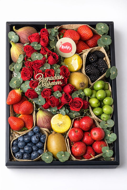 Fruit and flower arrangement with 'Ramadan Kareem' text on a white background