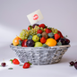 Fruit basket with a variety of fruits including apples, oranges, and strawberries on a white background.
