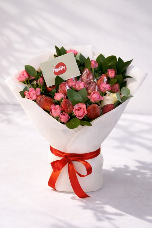 Bouquet of pink and red roses with a red ribbon on a white background
