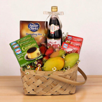 Basket with Foster Clark's dumpling mix, a bottle of wine, and fruits on a wooden surface.