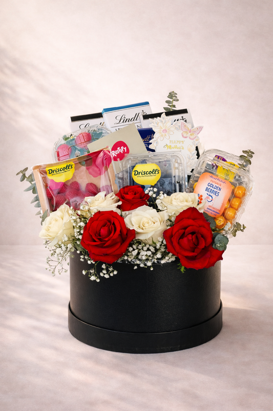 Gift basket with flowers and snacks on a white background