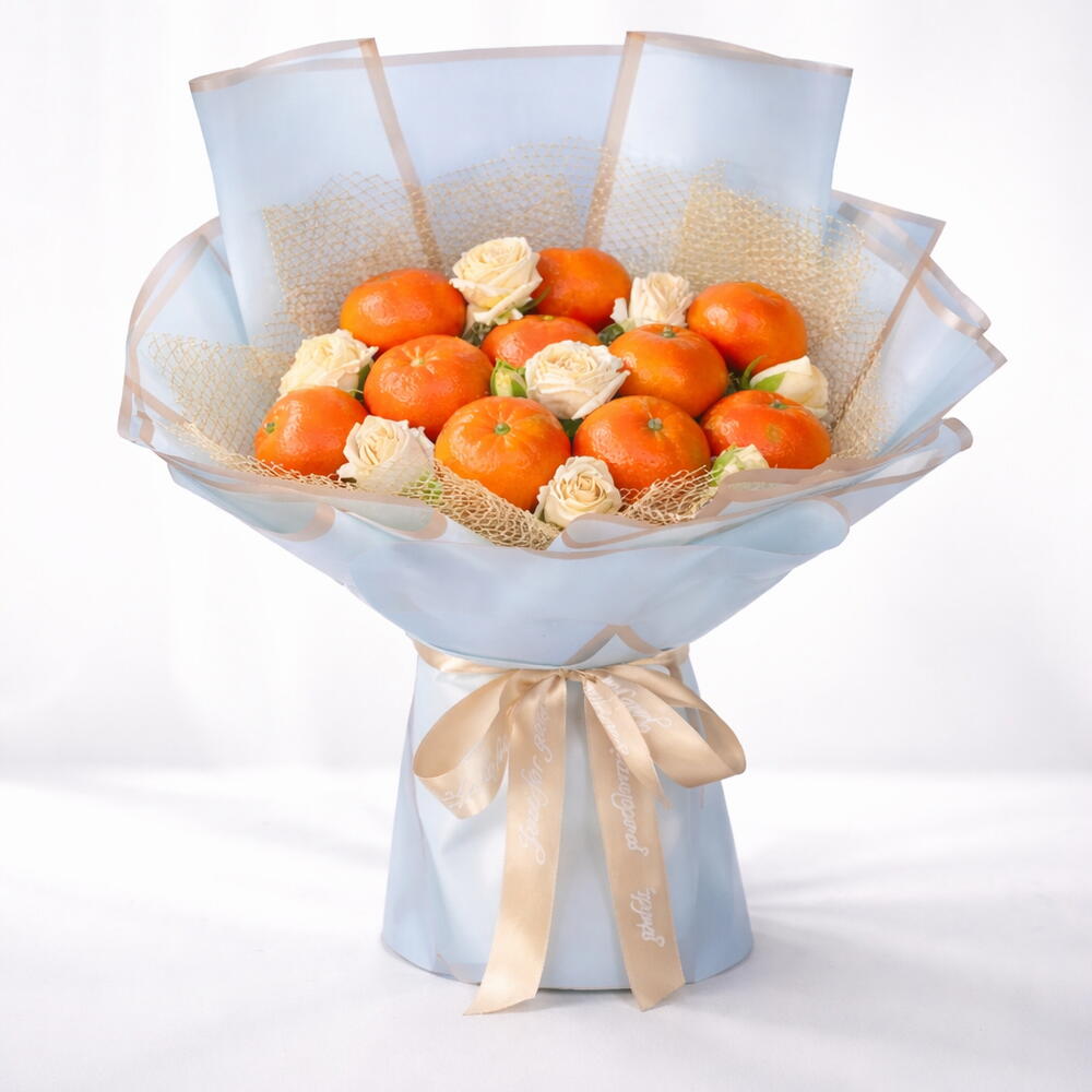 Bouquet of mandarins and white flowers wrapped in paper with a ribbon on a white background