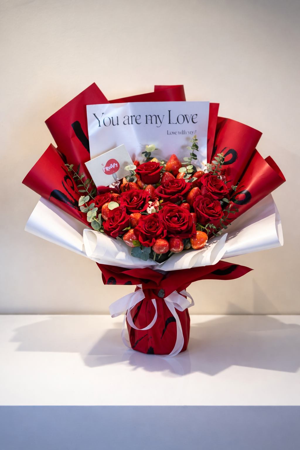 Bouquet of red flowers with a card inside on a white background