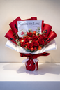 Bouquet of red flowers with a card inside on a white background