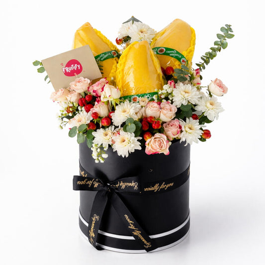 Black box with thai mango and flowers on a white background